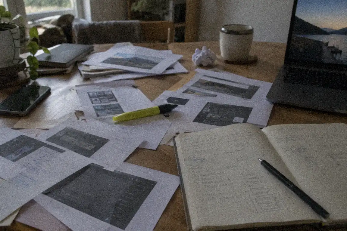 a laptop with screenshots and old notes open while rebuilding blog posts by hand