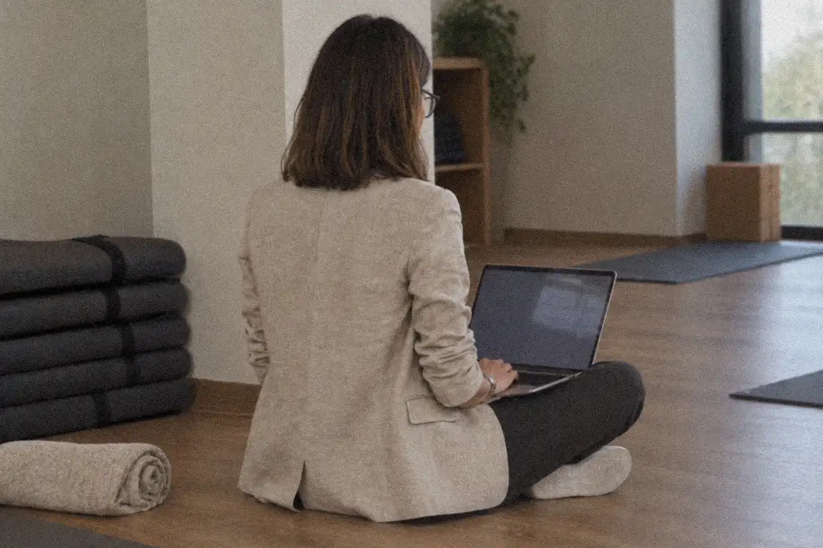 a notebook with a hand-drawn list of tick boxes beside a phone on a couch cushion